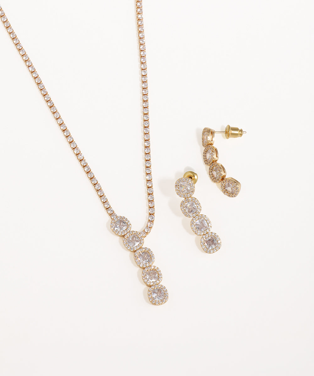Gold necklace and earrings on a white background