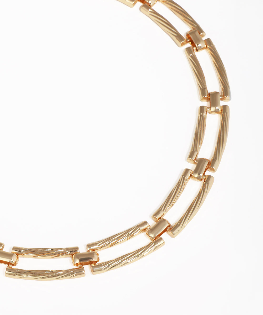 Gold chain bracelet on a white background