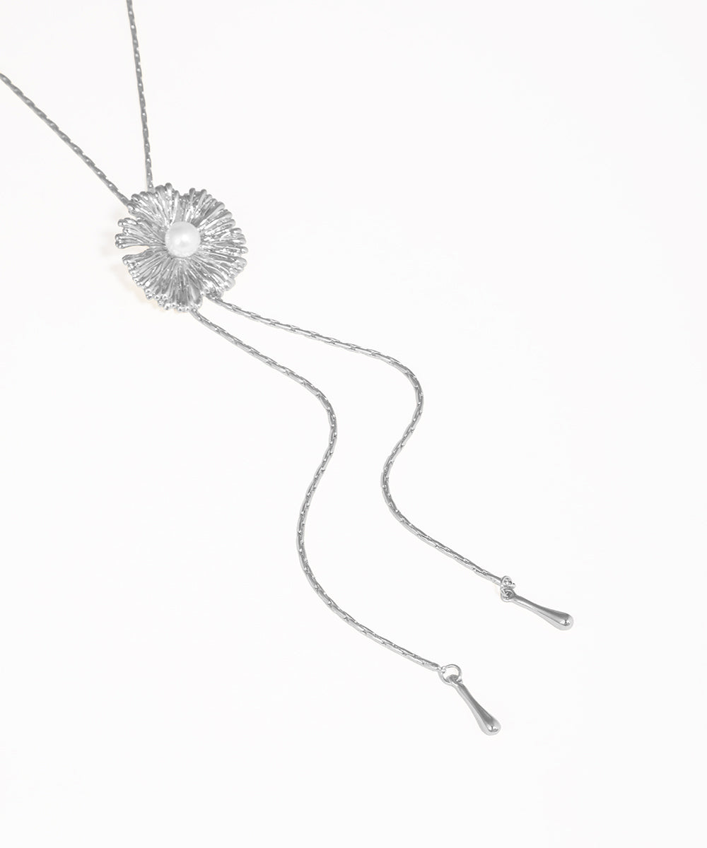 Silver necklace with a floral pendant on a white background