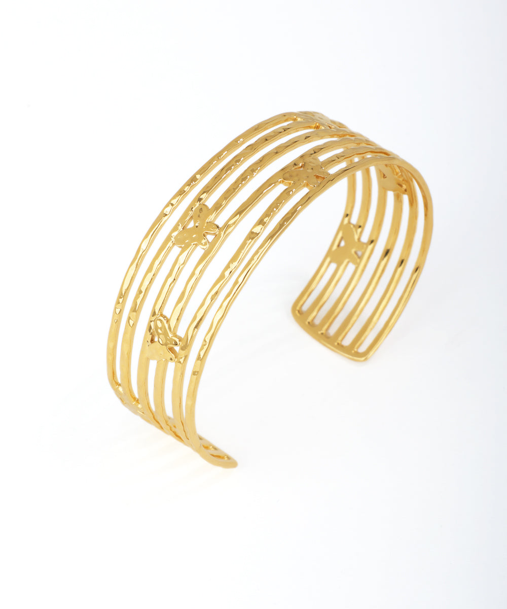 Gold bracelet with a butterfly design on a white background