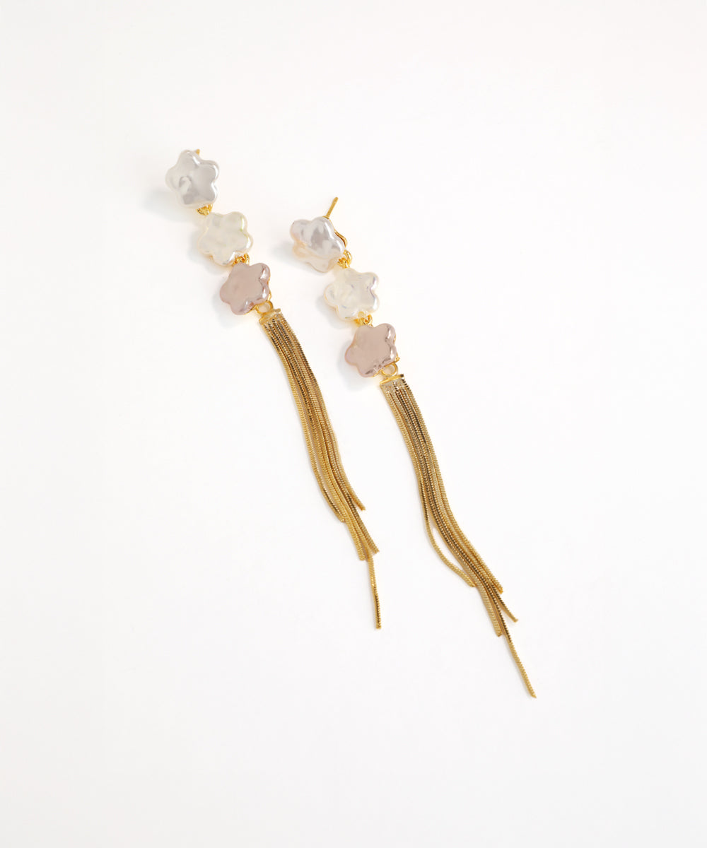 Earrings with beads and tassels on a white background