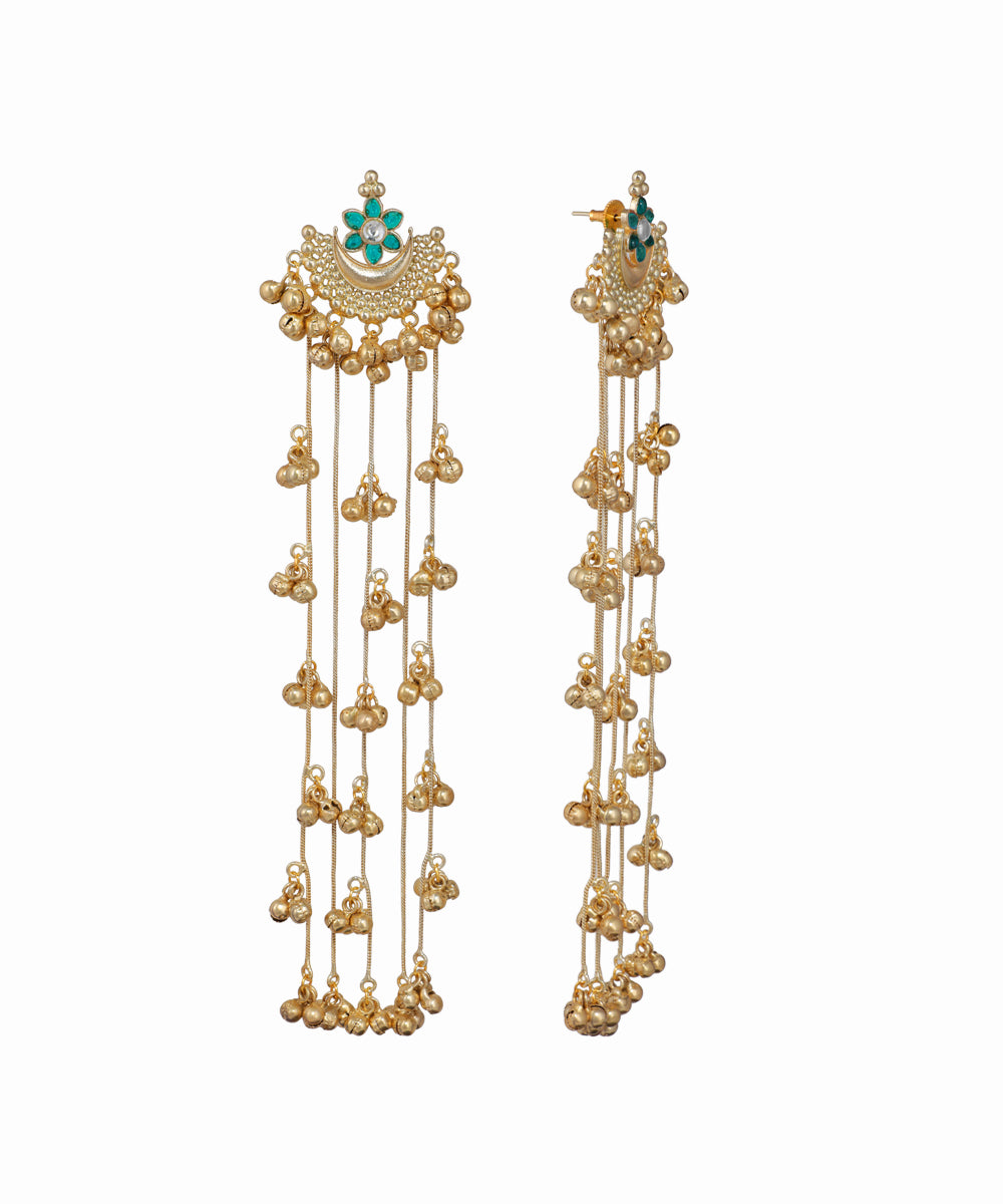 Gold earrings with intricate design and hanging elements on a white background