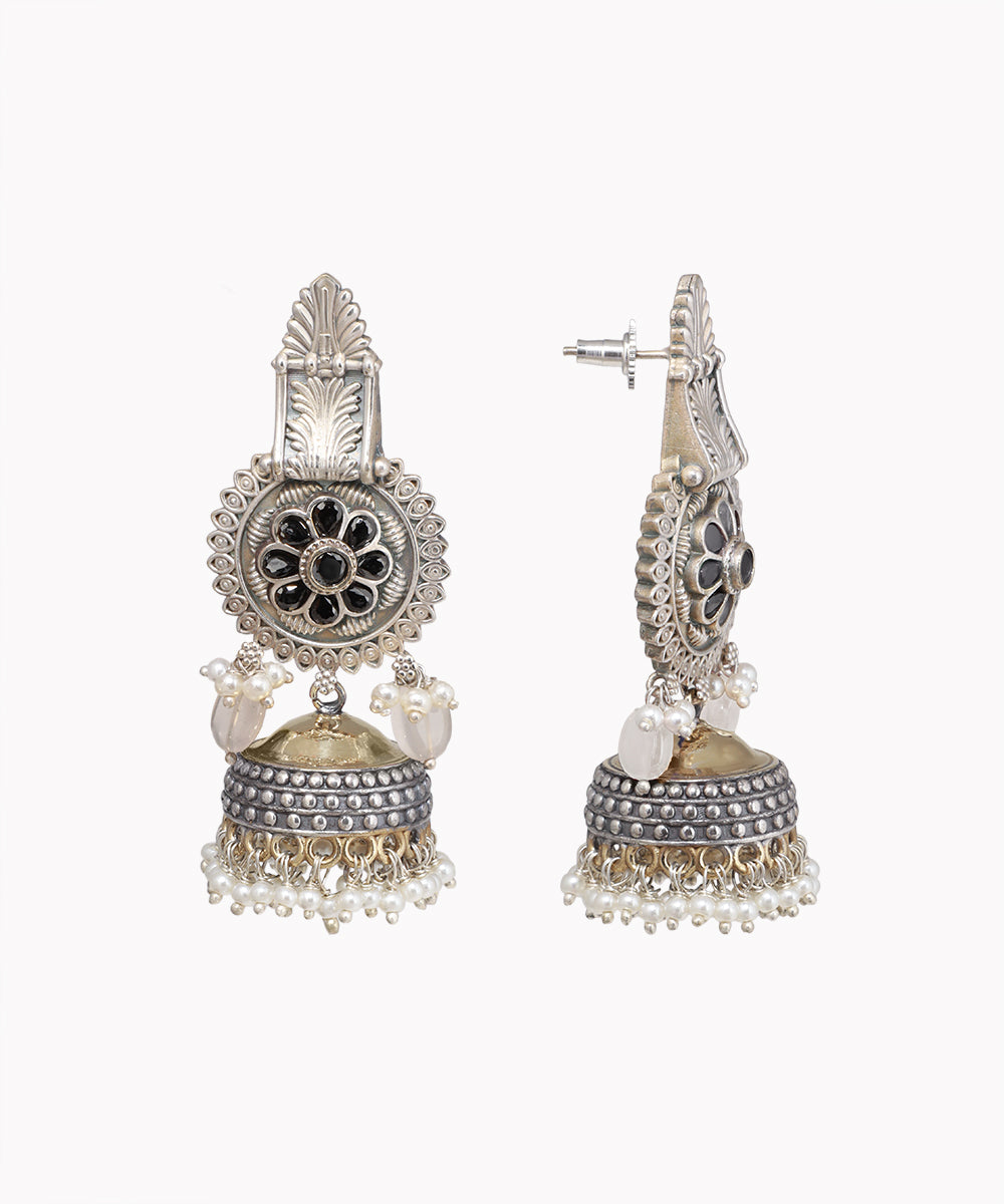 Ornate silver earrings with intricate designs on a white background