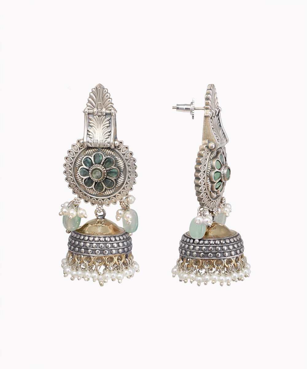 Decorative earrings with intricate designs on a white background