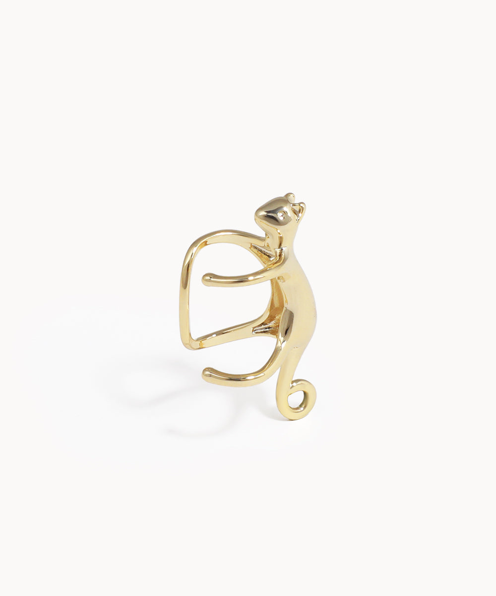 Gold cat-shaped ring on a white background