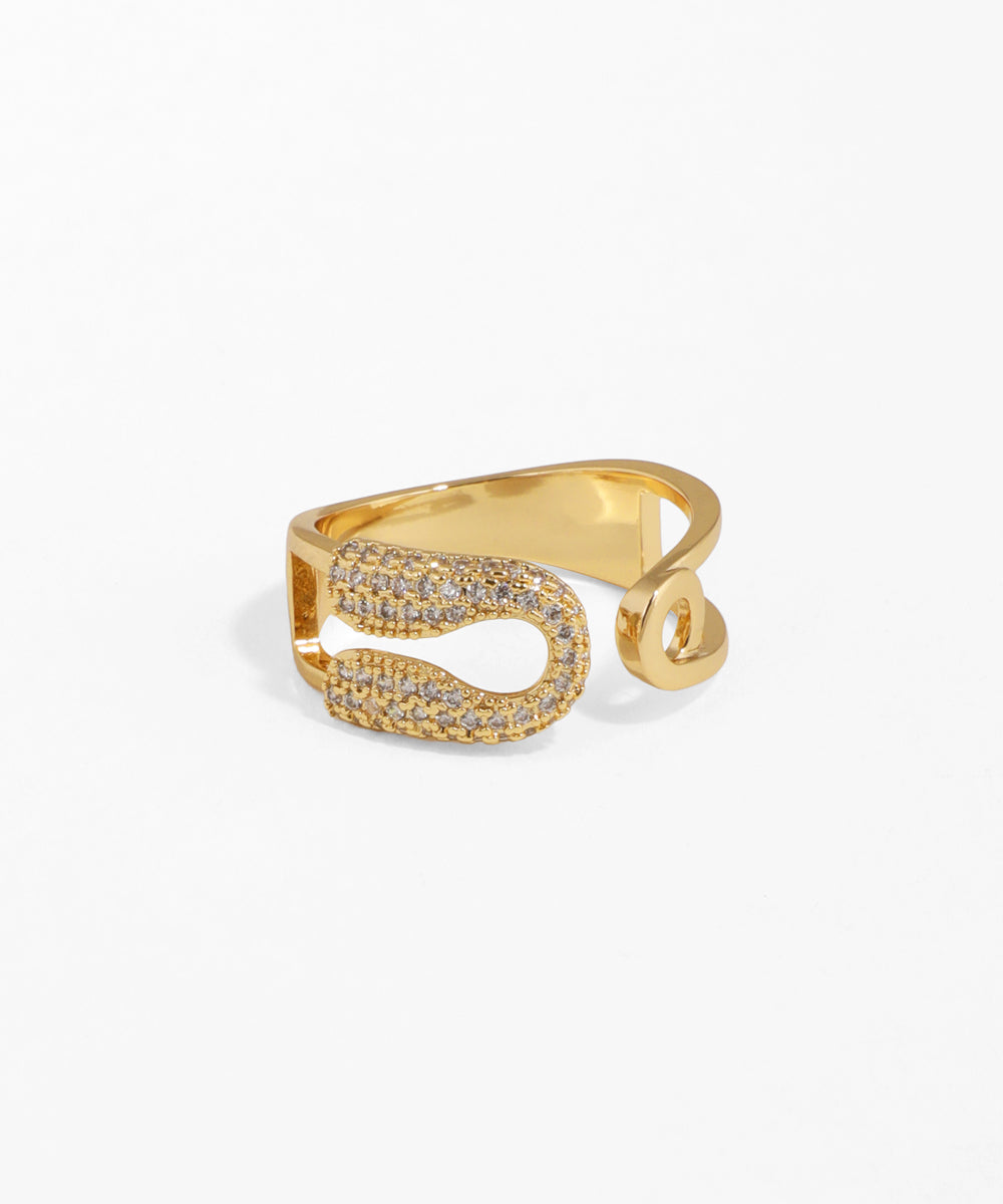 Gold ring with diamond accents on a white background