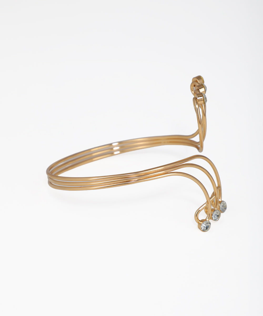 Gold bangle with small stones on a white background