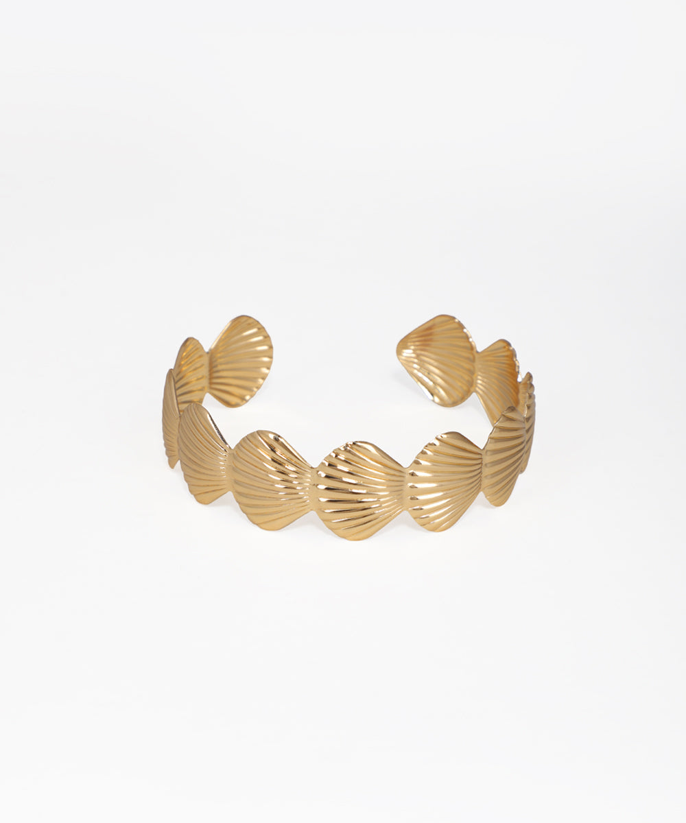 Gold bracelet with shell-like designs on a white background