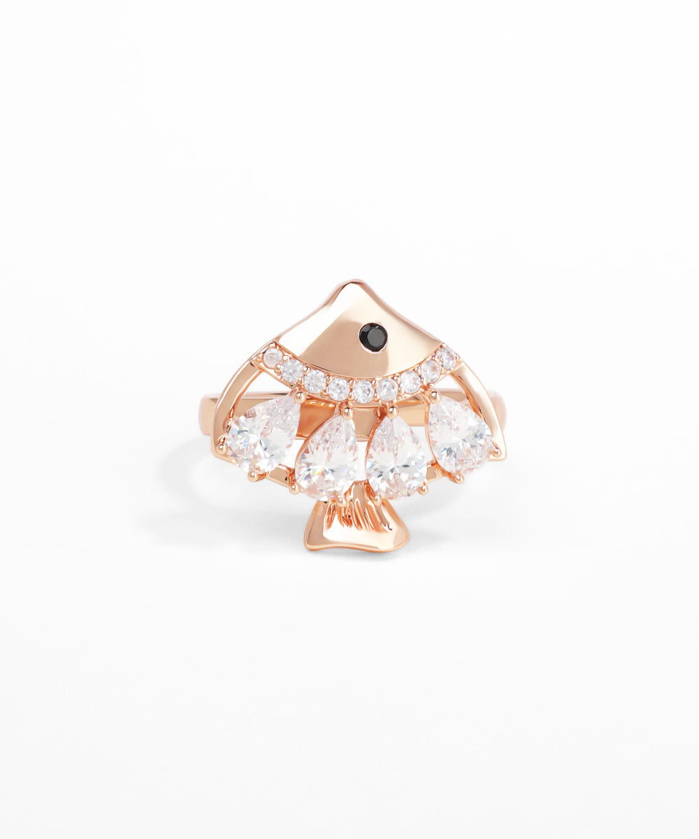 Rose gold ring with pear-shaped gemstones on a white background