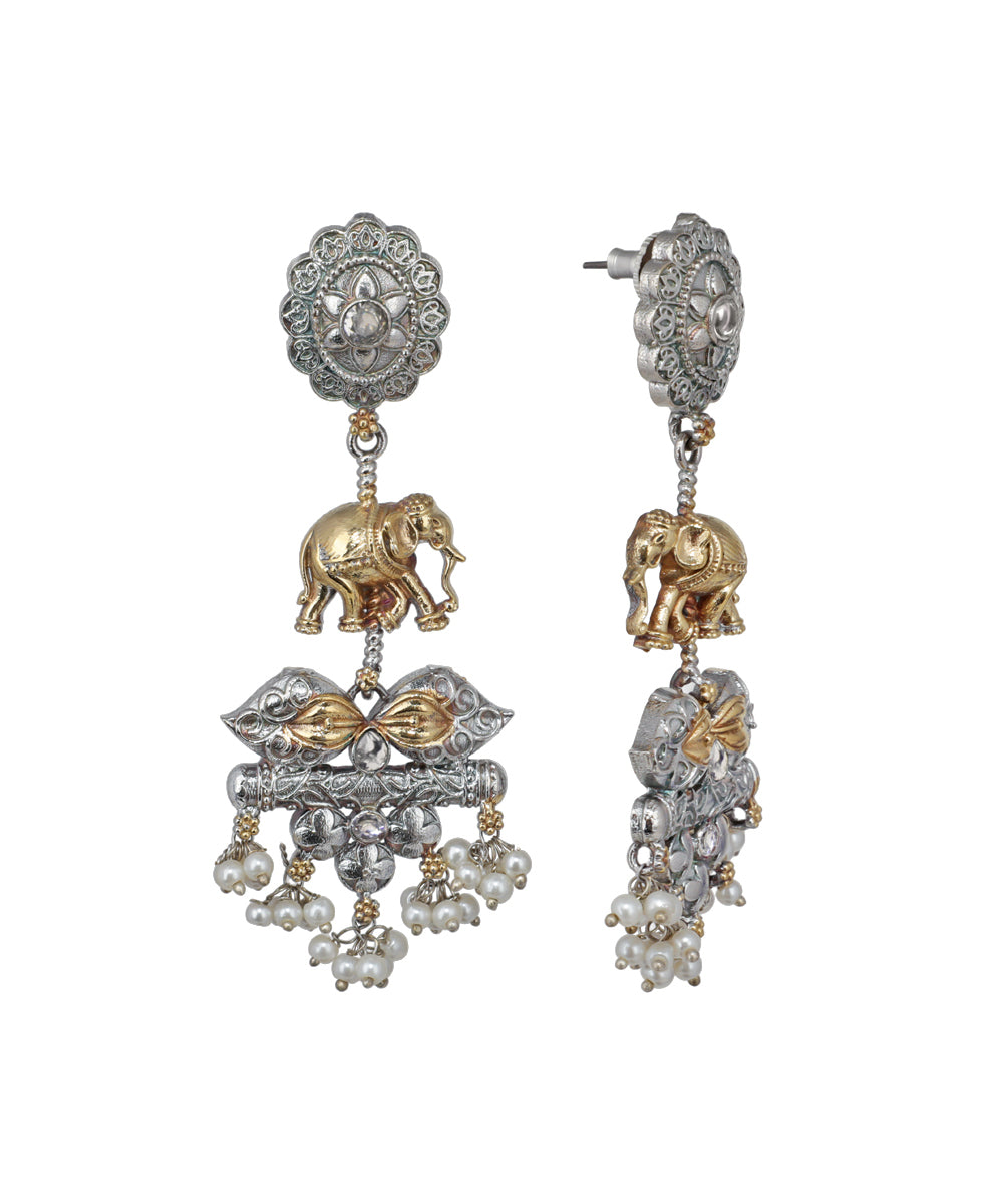 Ornate earrings with elephant design on a white background