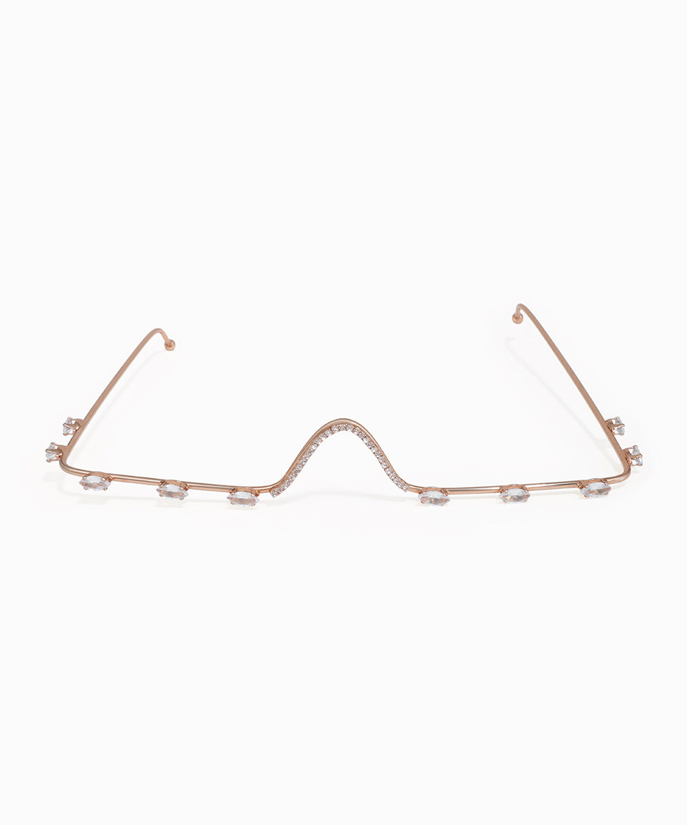 Rose gold necklace with small pearls on a white background