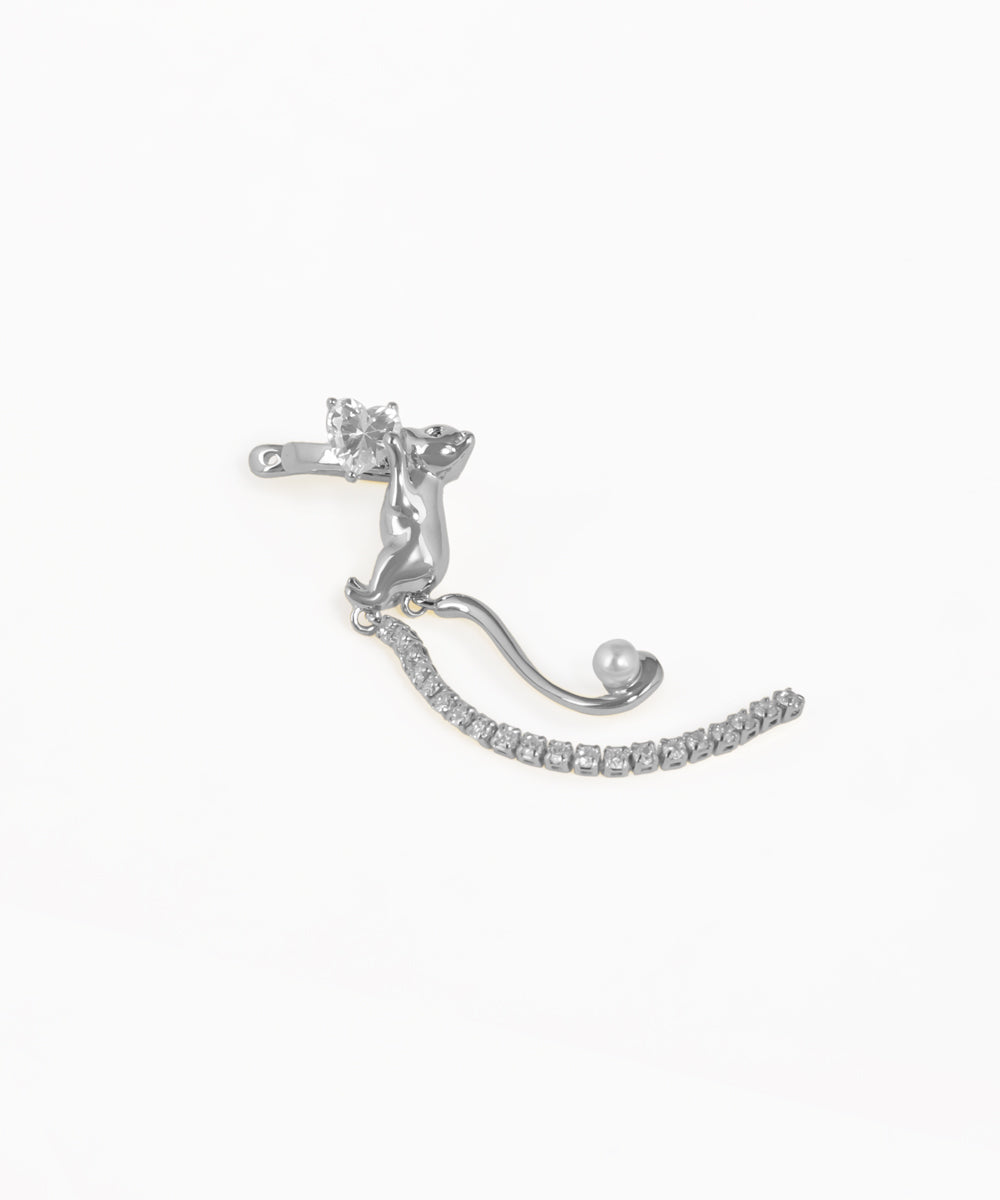 Silver earring with clear gemstones on a white background