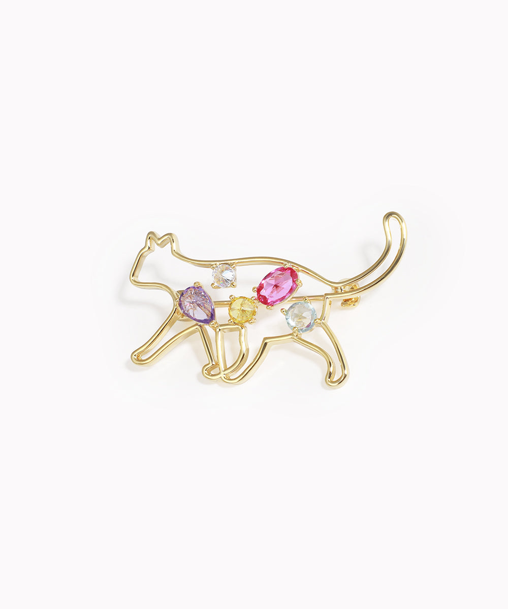 Gold-tone brooch with a cat outline design and colorful glass crystals