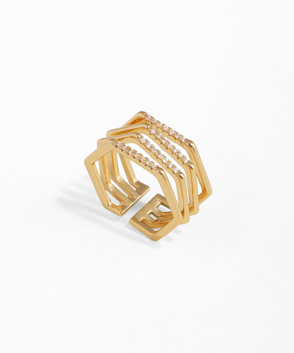 Gold-tone wide band geometric ring with three lines of clear cubic zirconia stones and an open design.