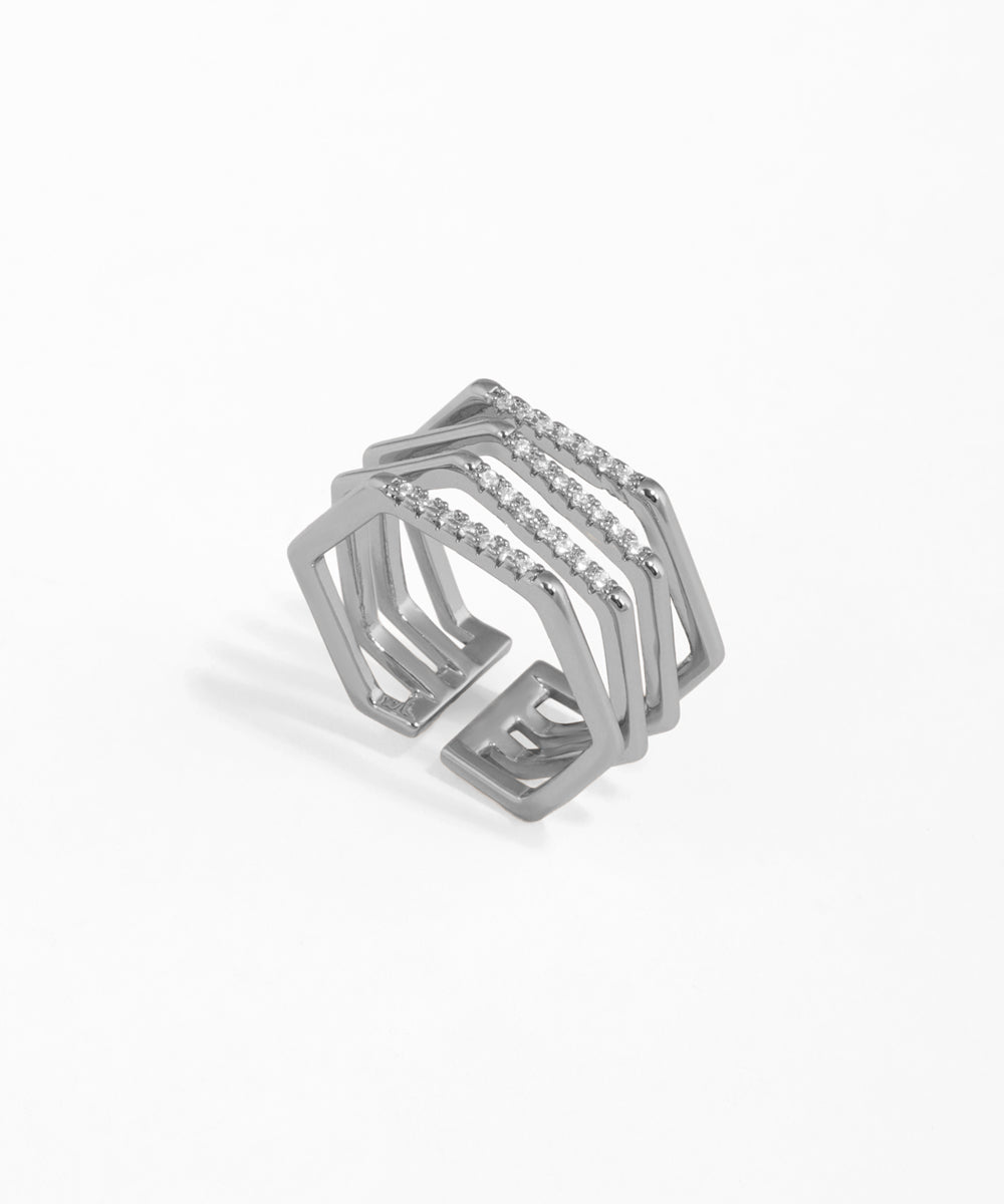 Silver geometric ring with small stones on a white background