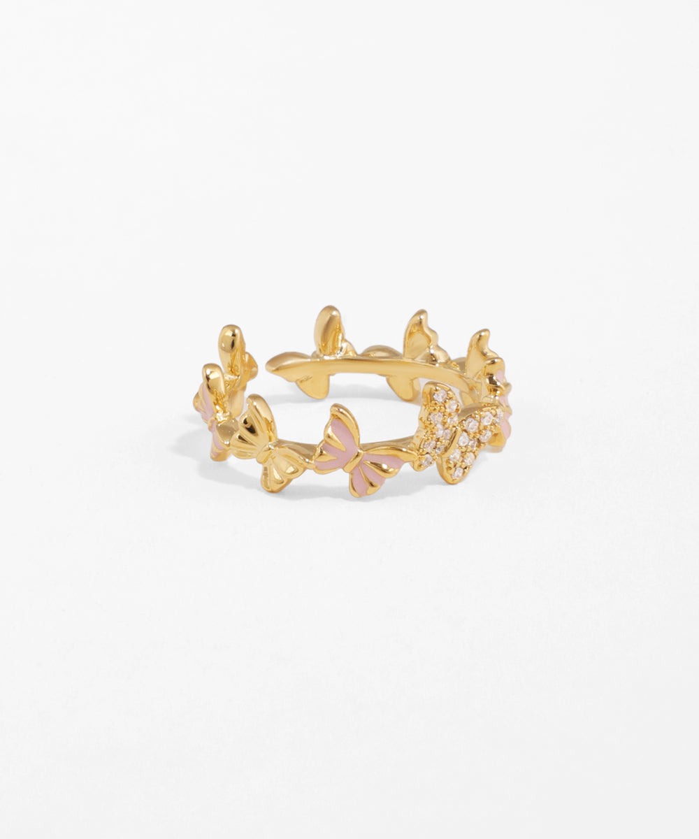 Gold ring with floral design on a white background