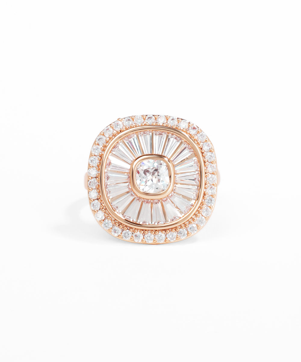 Rose gold and clear gemstone brooch on a white background