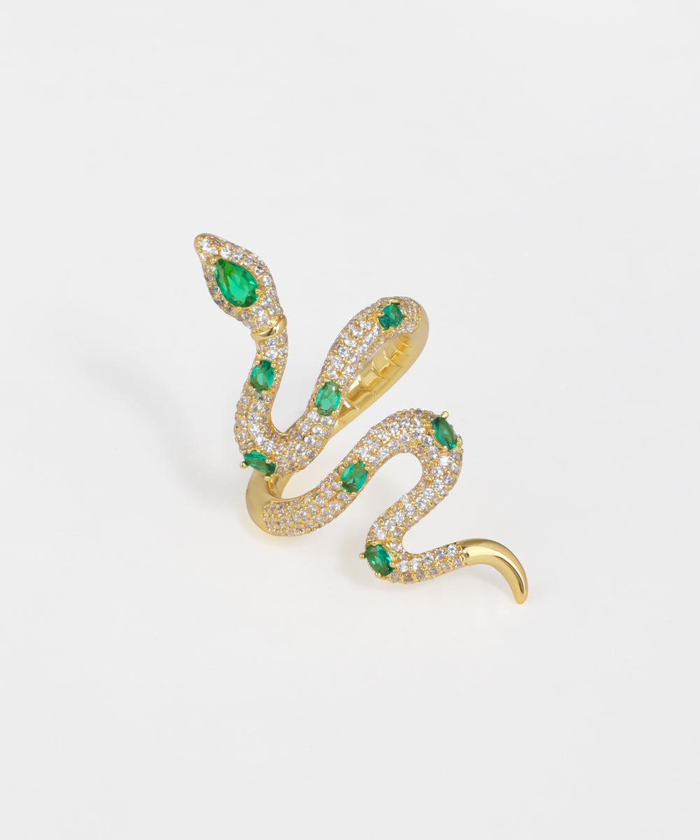 Gold-tone ring with winding serpent design, set with clear and green stones