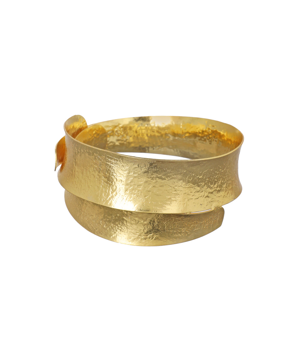Gold-tone arm cuff with hammered texture and a wide, wrap-around design