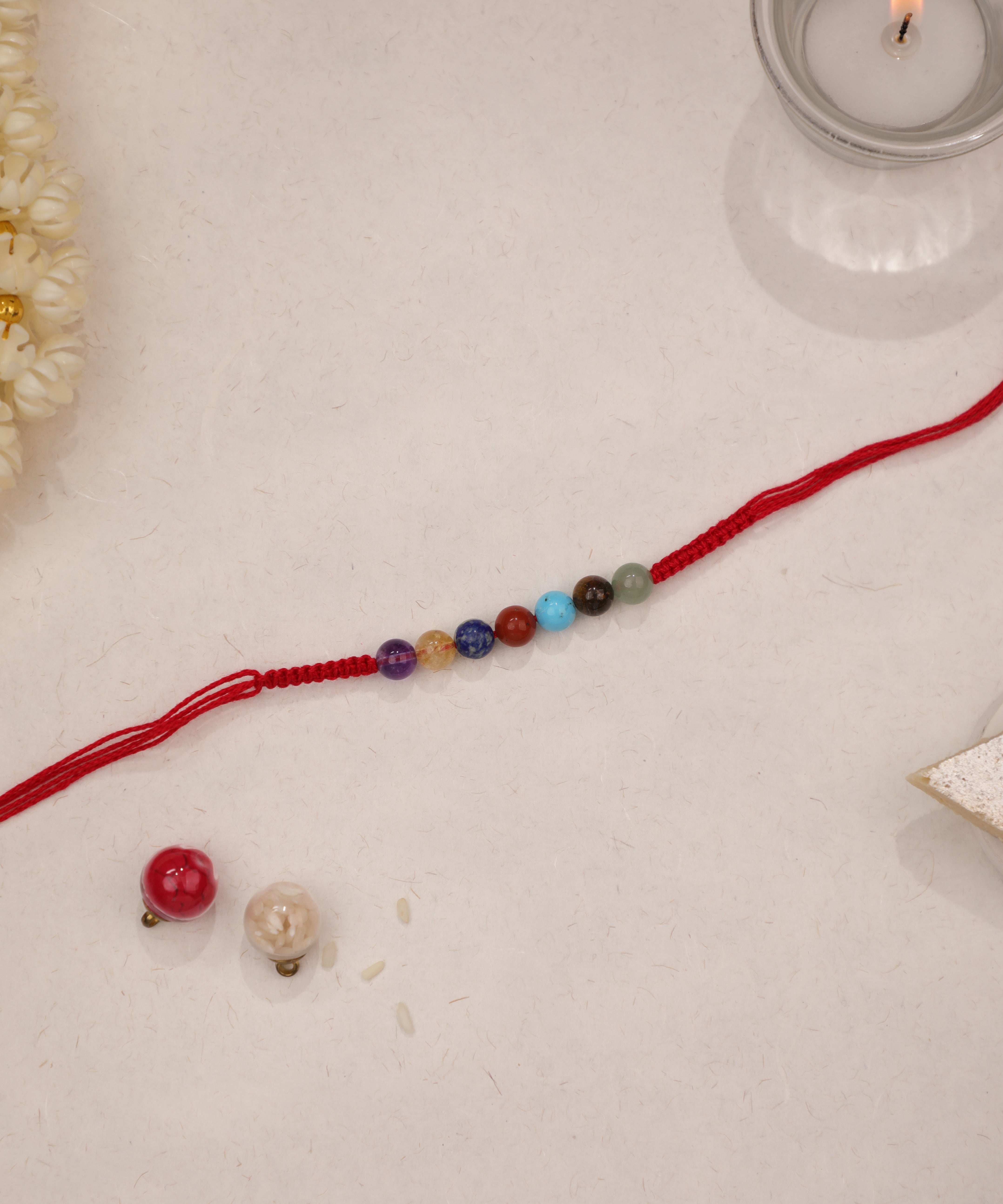 Red thread Rakhi with colorful round glass beads