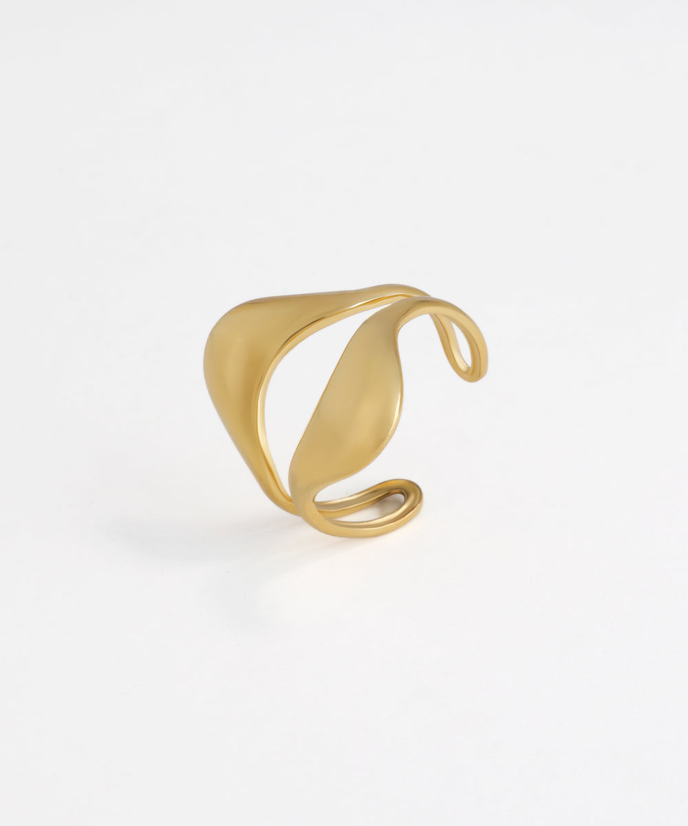 Gold-tone open ring with a sculptural wave design and smooth, matte finish.