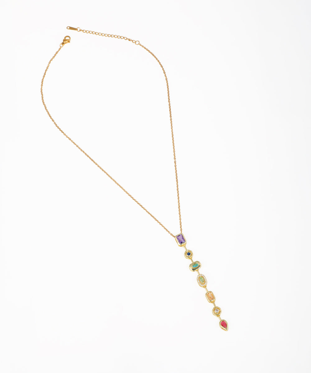 Gold-tone necklace with a long lariat drop featuring multiple colorful stones and clear accent crystals.