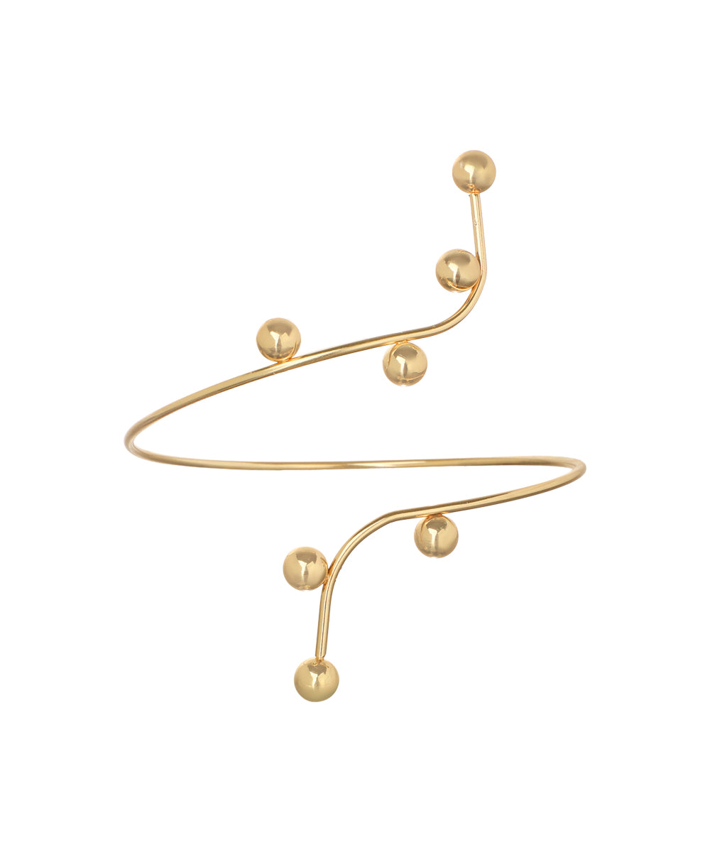 Gold-tone arm cuff with winding sculptural design and polished spherical accents