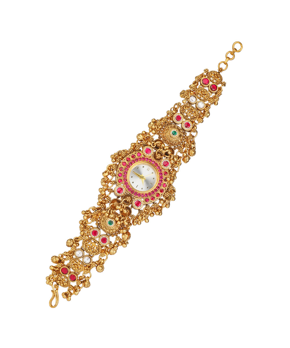 Gold-tone heritage watch with red, green, and clear glass stones, and faux pearls