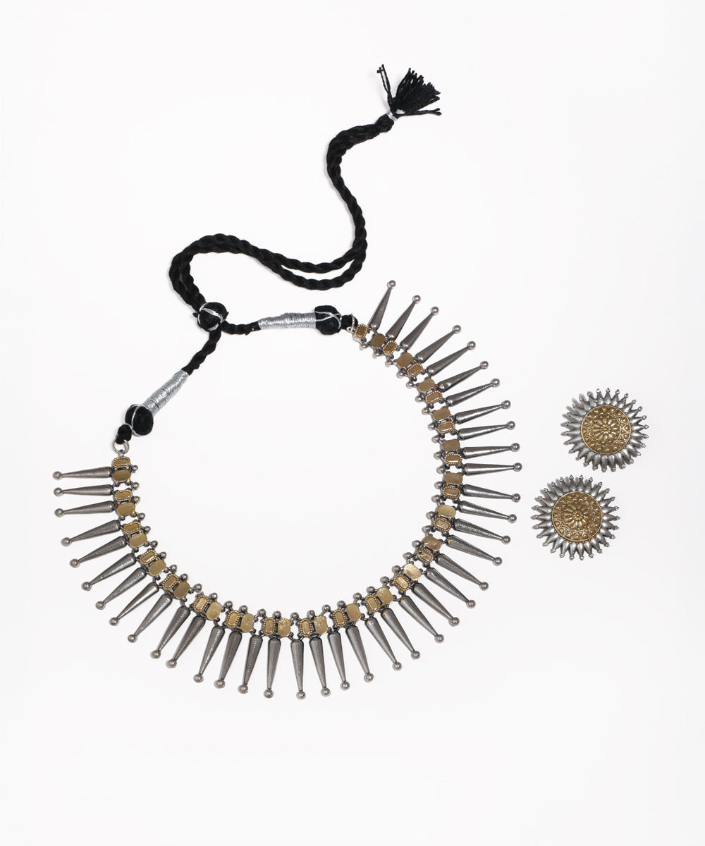 Oxidised silver-tone and brass-tone necklace with spike details and matching stud earrings.