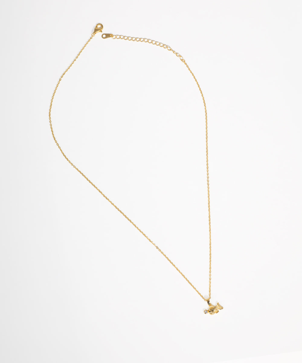 Gold-tone necklace with a small bird-shaped pendant featuring a clear stone accent on a thin chain.