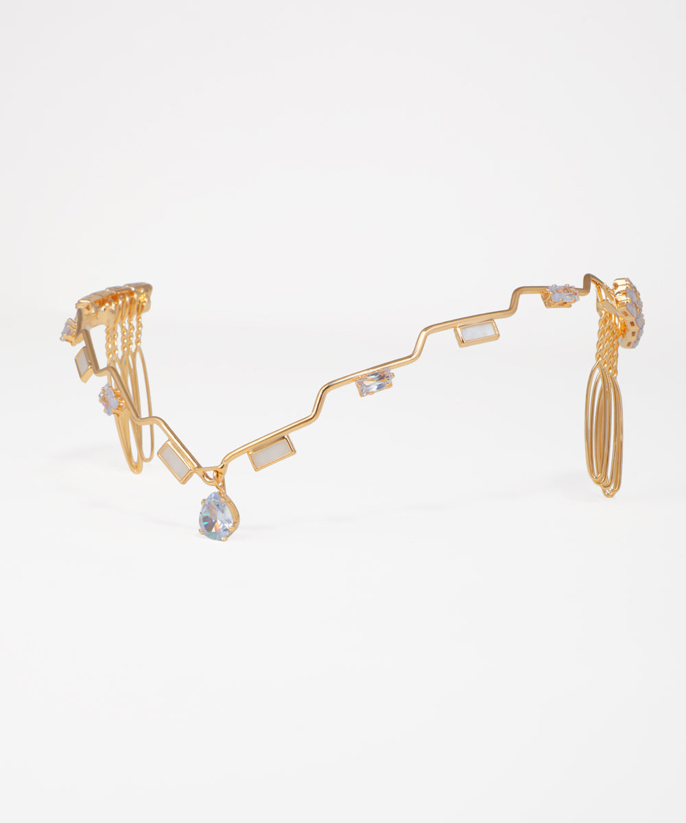 Gold-tone tiara with wavy design, clear CZ, and opaque rectangular stones, secured with hair combs.