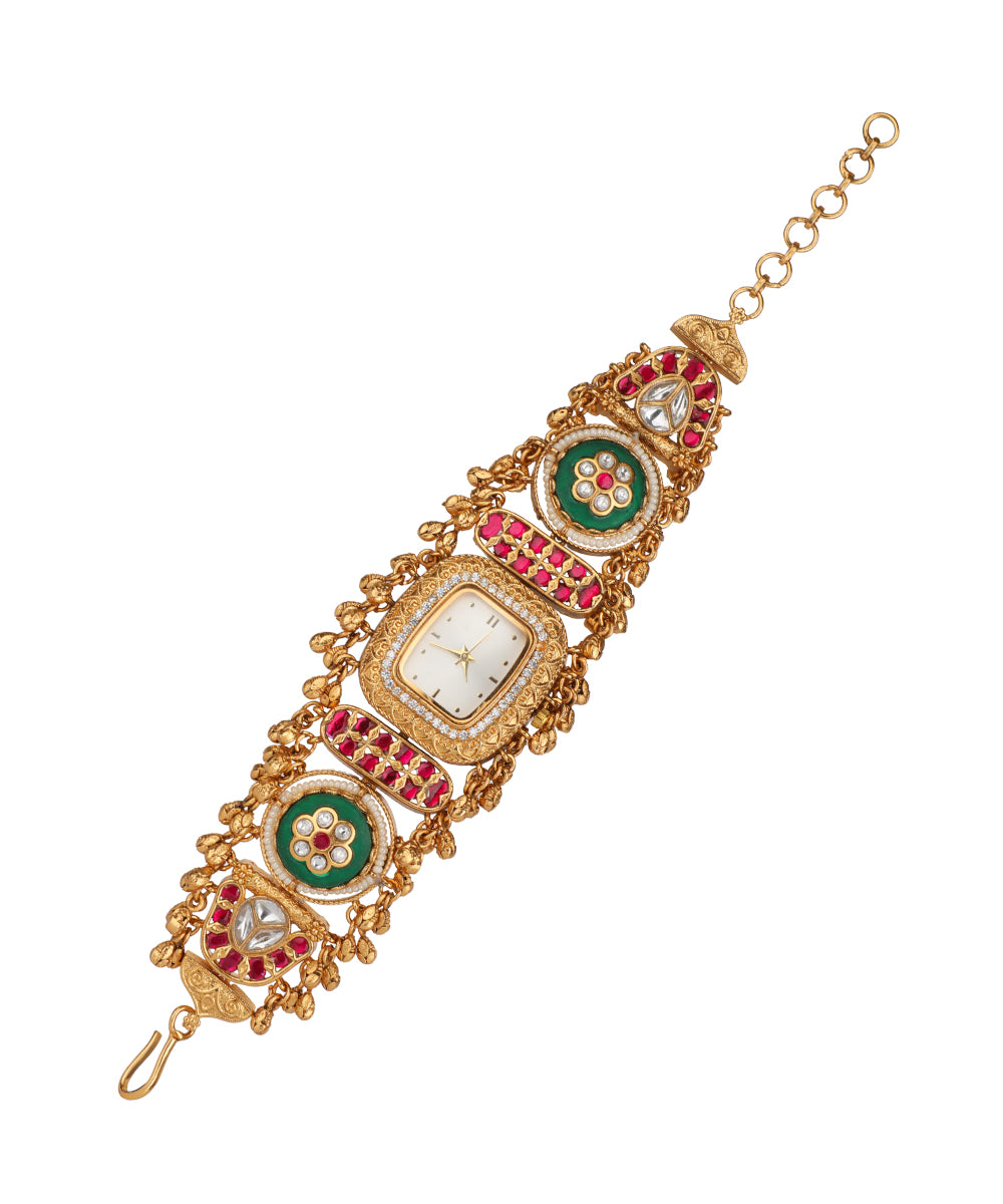 Gold-tone heritage watch with ornate red and green stones, clear CZ, and intricate traditional design details
