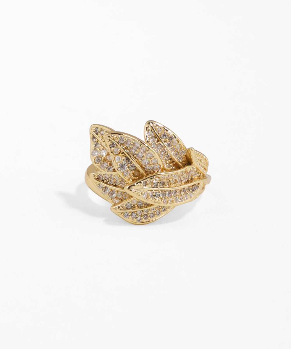 Gold ring with diamond accents on a white background
