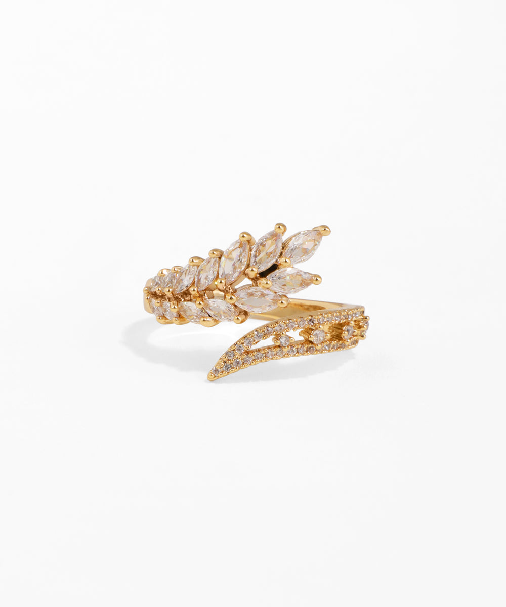 Gold ring with diamond-like stones on a white background