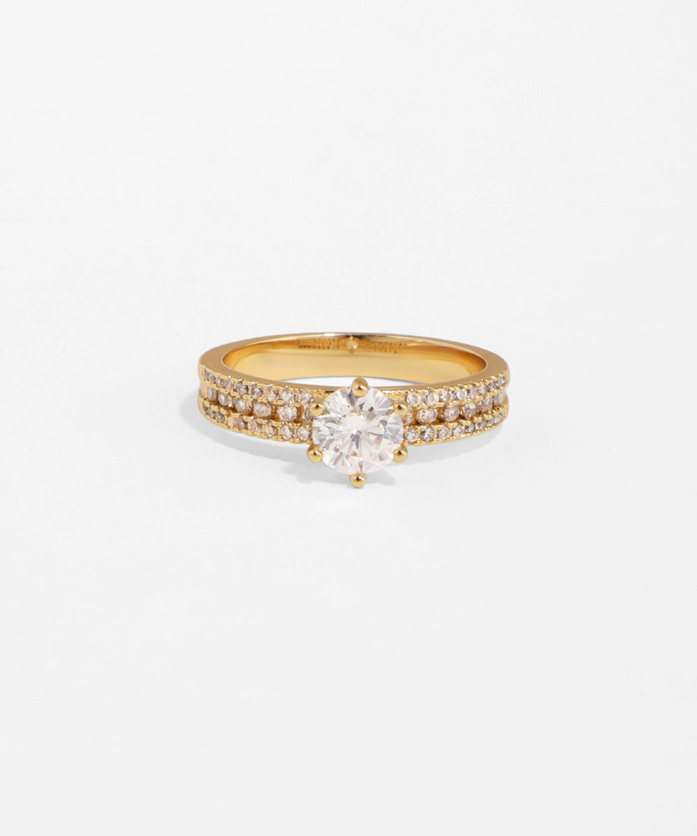 Gold ring with a diamond on a white background
