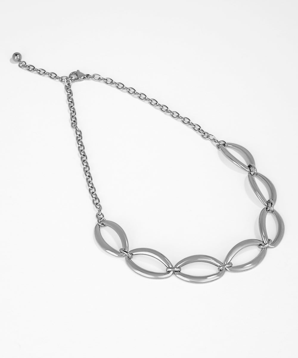 Silver necklace with interlocking links on a white background