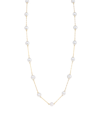Gold-tone necklace with spaced white faux pearls on a delicate chain
