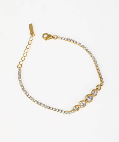 Gold-tone bracelet with graduated bezel-set and line of clear stones