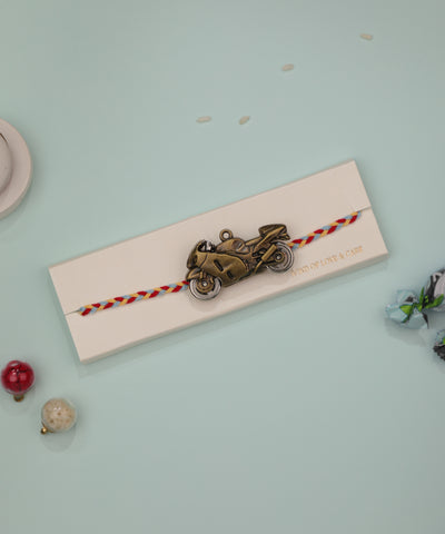 Antique bronze-tone motorcycle charm rakhi band with braided multi-color thread
