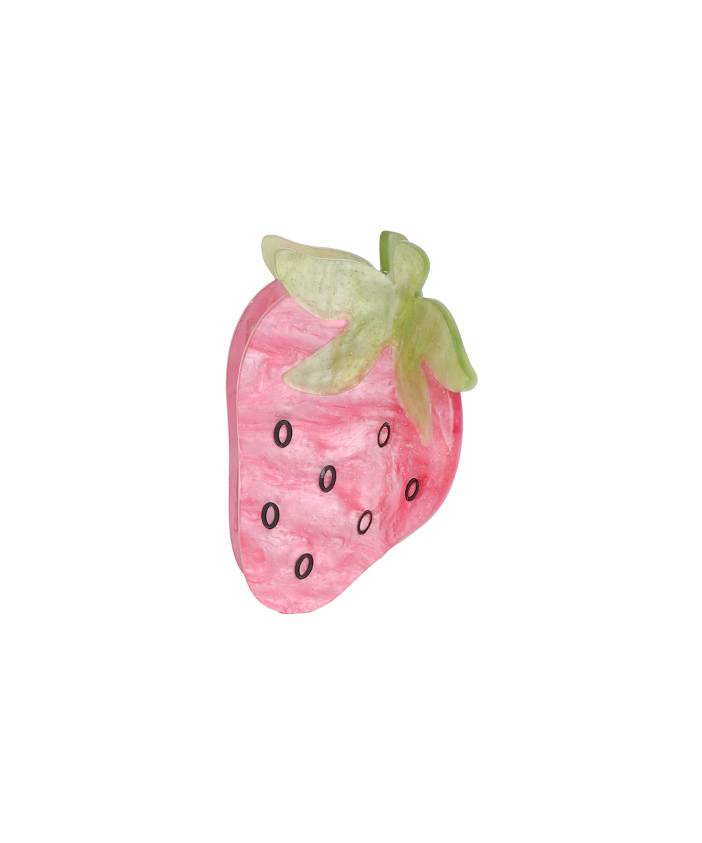 Pink and green hair clutch with a marbled strawberry shape and black seed accents.