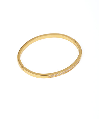 Gold bangle with embedded stones on a white background