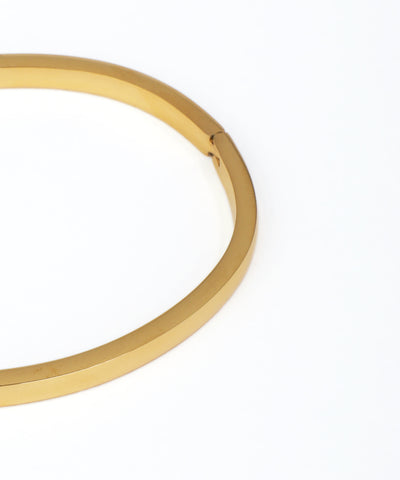 Gold bangle on a white background