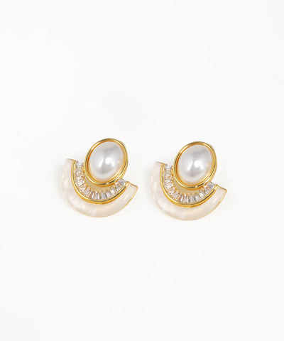 Pair of earrings with pearl-like stones and gold accents on a white background