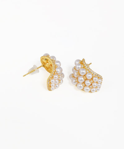 Gold crescent stud earrings featuring clustered pearls and sparkling stones