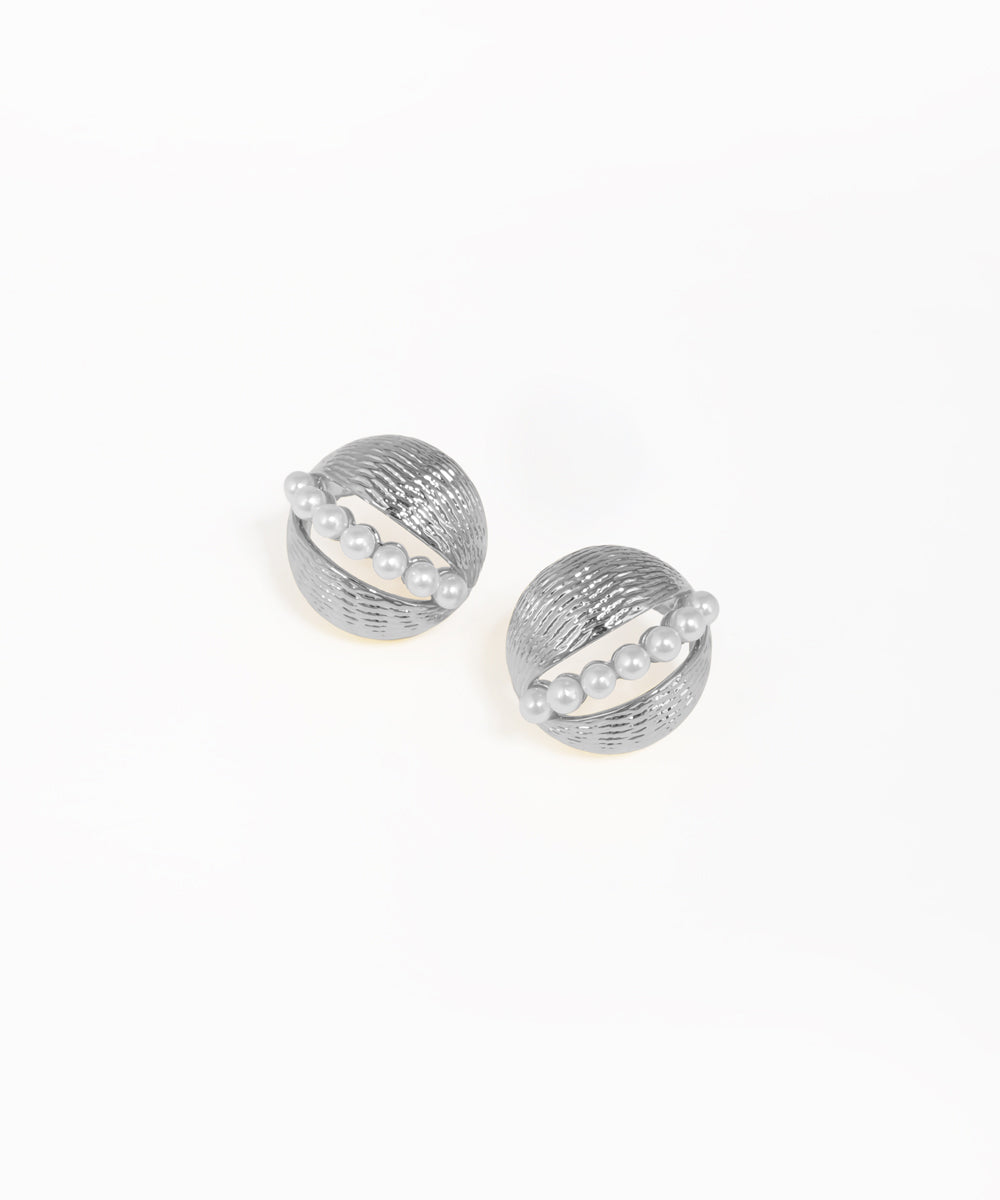 Gold dome stud earrings featuring a pearl centerpiece and textured ridged detailing
