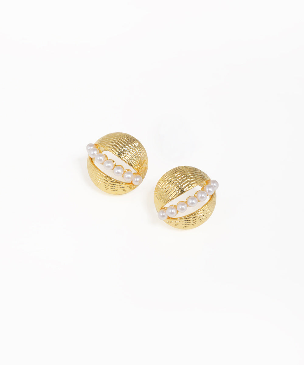 Pair of gold earrings with pearl-like stones on a white background