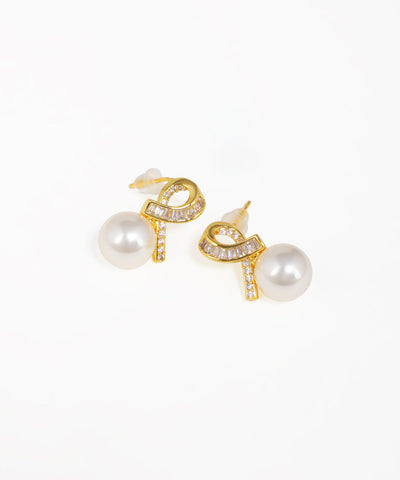 Gold knot stud earrings featuring elegant drop detailing