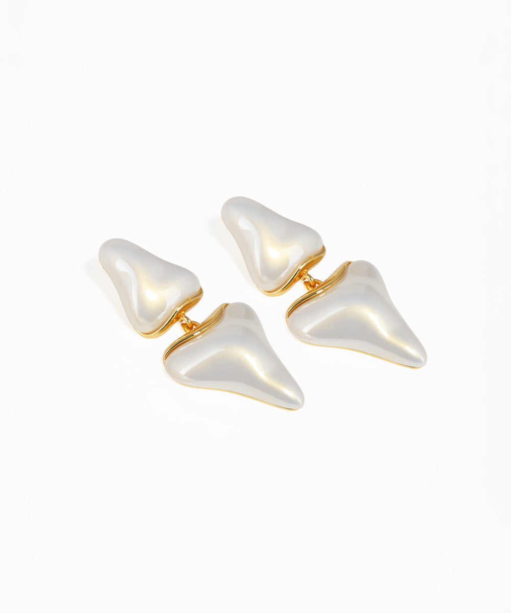 Gold abstract drop earrings featuring layered sculptural shapes
