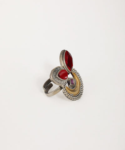 Multicolored ring with red gemstone on a white background