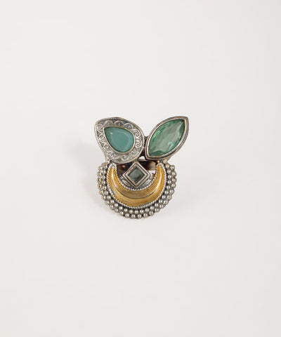 Decorative ring with green stones and gold accents on a white background